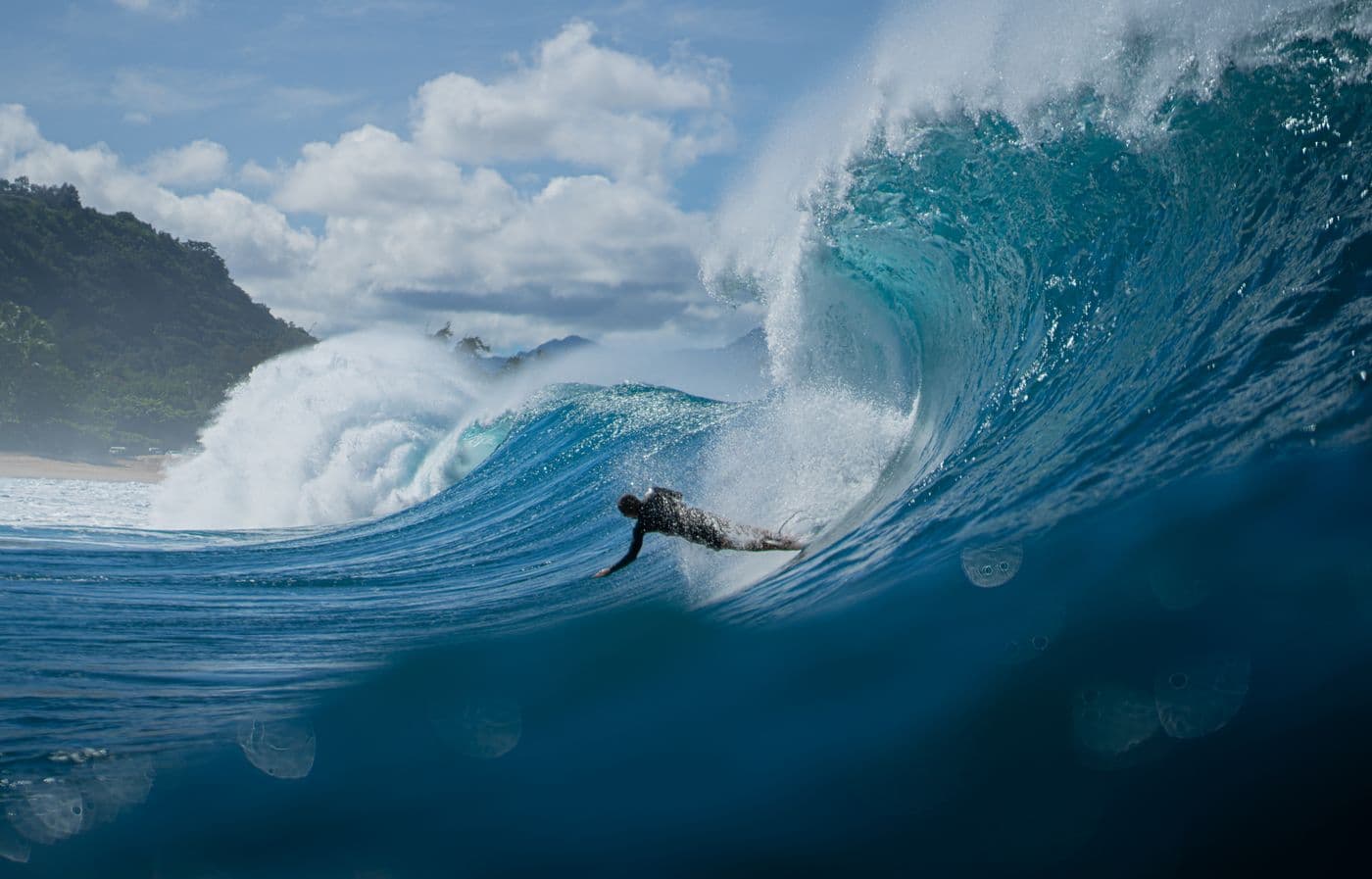 A surfer moving across the face of a wave